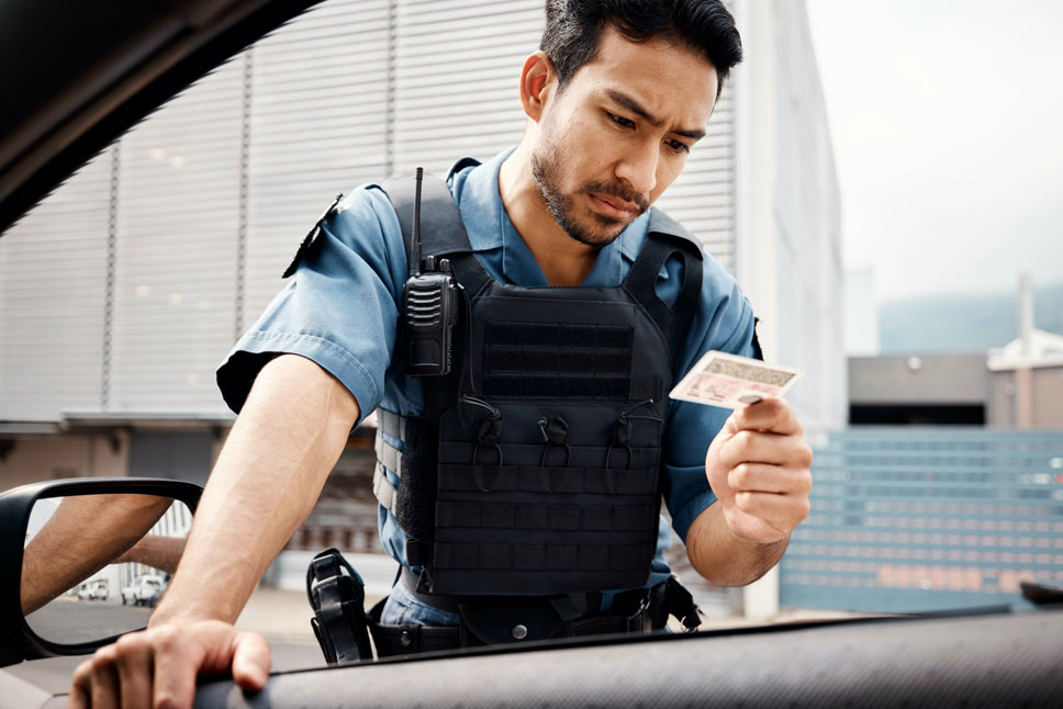 police or law enforcement checking drivers license for id verification.