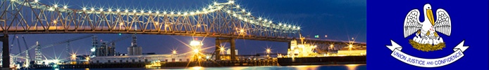 A brightly-lit bridge with the state flag of Louisiana.