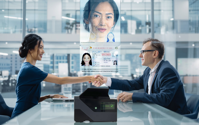 woman and man shaking hands after successfully authenticating an ID using a Keesing Scanner.